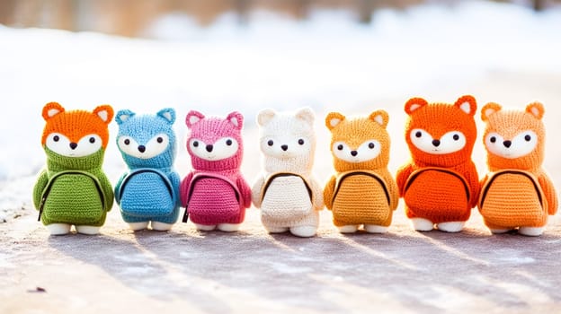 Line of colorful knitted fox toys with backpacks.