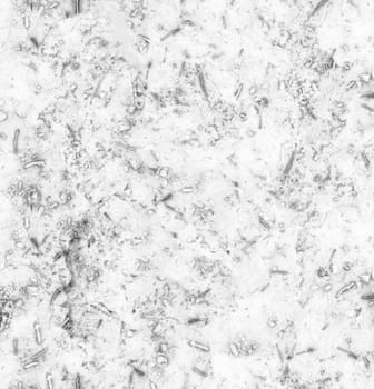 Abstract grey grunge-style background with fibers spots and dirt close-up from above