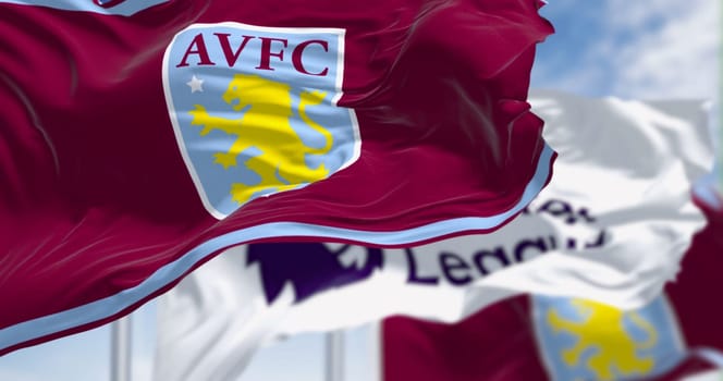 Birmingham, UK, Oct. 21 2023: Aston Villa and Premier League flags waving on a clear day. Fluttering fabric. Illustrative editorial 3d illustration render. Waving flag