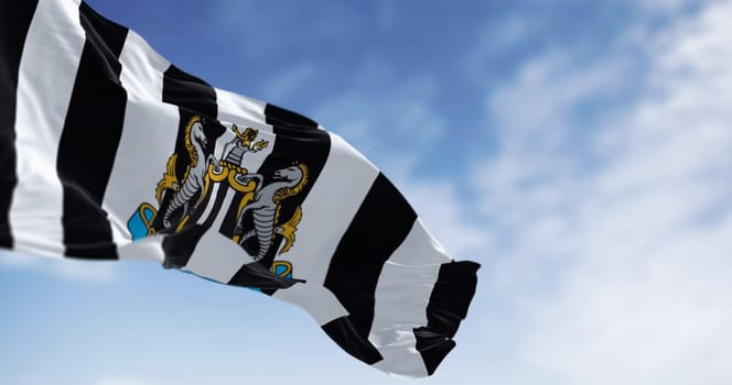 Newcastle, UK  sept. 14 2023: Newcastle Football Club flag waving on a clear day. Illustrative editorial 3d illustration render. Fluttering fabric. Selective focus