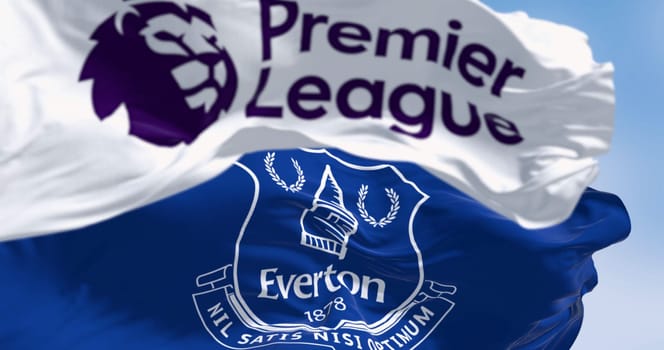 Liverpool, UK, Sept. 21 2023: Everton Football Club flag waving with Premier League flag. Professional english football club. Illustrative editorial 3d illustration render. Selective focus