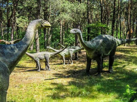 Vulcanodon Sauropods in the forest, herd of sauropods, parents and offspring.