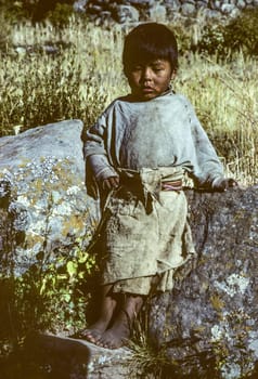 Taquile, Peru - February 7, 1985: portrait of local young boy  in traditonal way linen at island Taquile in lake Titicaca.