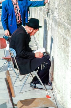 1994:, Israel, Jerusalem - December 30, 1994: orthodox man prays at the western wall at the holy temple wall in Jerusalem.