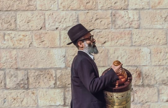 Jerusalem, Israel - January 1, 1995:   Orthodox jewish man prays at the Western Wall in Jerusalem, Israel. Israel's annexation of East Jerusalem in 1967, including the Old City, was never internationally recognized.