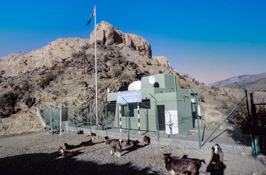 Jebel Shams, Oman - June 14, 1996: goats rest in front of radar station in the Oman.