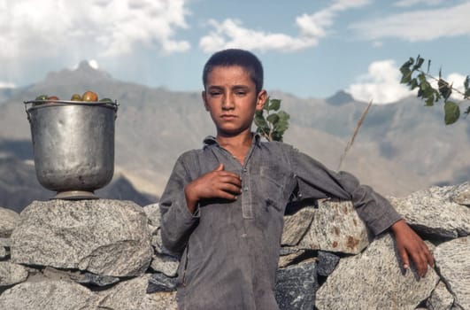 Gilgit, Pakistan - June 30, 1987: portrait of unknown working boy in Gilgit, Pakistan. People suffer in that area because of the Afghanistan war.