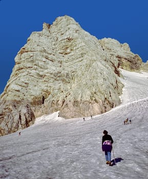 Dachstein, Austria - March 5, 2001: people enjoy climbing the Dachstein mountain in the Alps ia the Randkluftsteig, an old route from the 19th century.