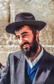 Jerusalem, Israel - January 1, 1995:   Orthodox jewish man prays at the Western Wall in Jerusalem, Israel. Israel's annexation of East Jerusalem in 1967, including the Old City, was never internationally recognized.