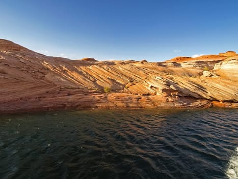 Lake Powell is based on Colorado River with a great view on the canyoon. Beautiful canyon and lonely rocks on the Lake Powell, Utah.