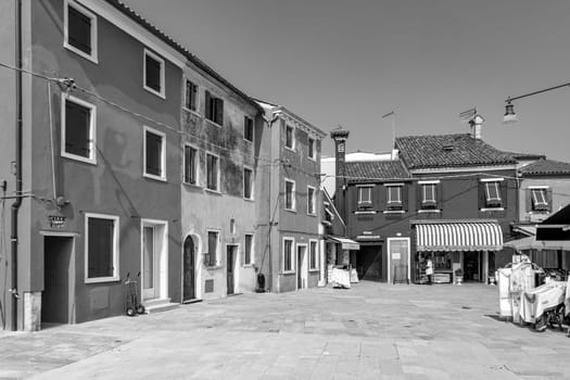 Burano, Italy - April 10, 2007: scenic historic town square in the village of Burano in different colors.