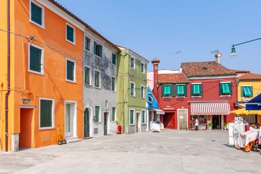 Burano, Italy - April 10, 2007: scenic historic town square in the village of Burano in different colors.