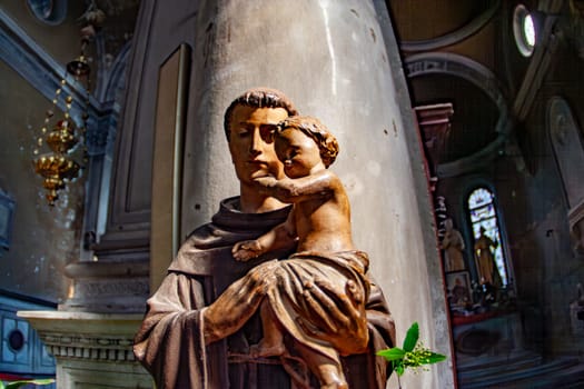 Venice, Italy - April 10, 2007: cemetery island of San Michele, figure in the church looking graceful and holy with child in arm.