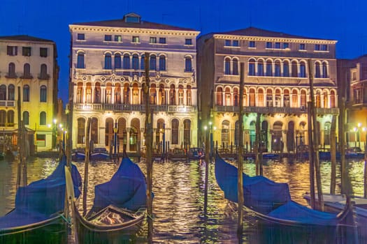 Venice, Italy - April 11, 2007: view to old palace at the grand canal in Venice with gondolas parking in foreground.