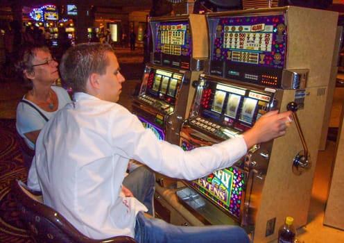 Las Vegas, USA - May 31, 2007: people enjoy playing at the slot machine in Las Vegas, USA.