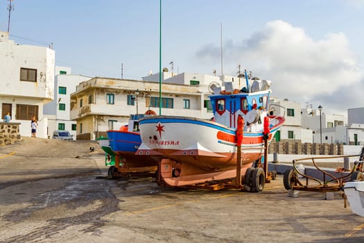 Famara, Spain - August 4, 2007: fishermen prepare the old wooden fishing boat for the next turn in Famara.