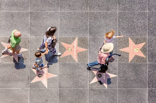 Los Angeles, USA- July 5, 2008: people passing the walk of fame in Hollywood on a sunny day in Los Angeles, USA