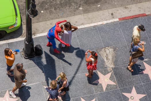 Los Angeles, USA - July 5, 2008: people in costumes like spiderman offer a picture with tourists for a tip in Hollywood at the walk of fame.