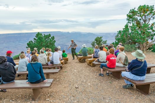 Grand Canyon, USA - July 10, 2008: park ranger explains the geology of the Grand canyon at Hopi point to tourists.
