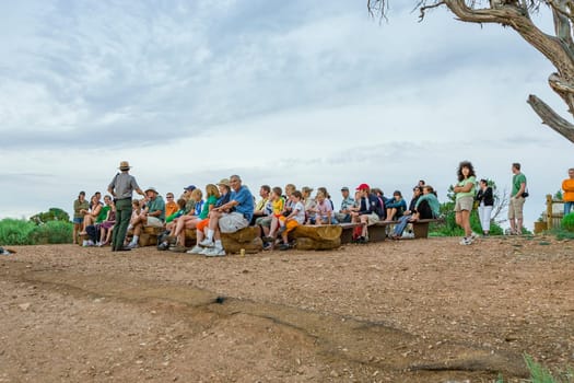 Grand Canyon, USA - July 10, 2008: park ranger explains the geology of the Grand canyon at Hopi point to tourists.