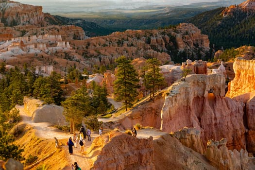 Bryce Canyon, USA - July 16, 2008: people enjoy the morning walk in sunrise at the scenic rock hoodoos in the Bryce Canyon national park.