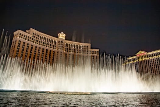 Las Vegas, USA - July 17, 2008:  Las Vegas Bellagio Hotel Casino, featured with its world famous fountain show, at night with fountains  in Las Vegas, Nevada.