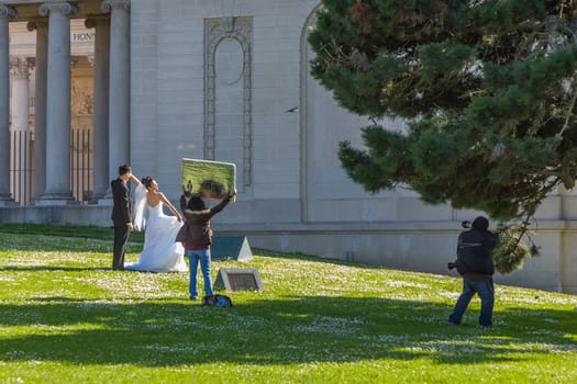 San Francisco, USA - July 23, 2008: wedding couple poses in front of the honor of legion for a wedding photo.