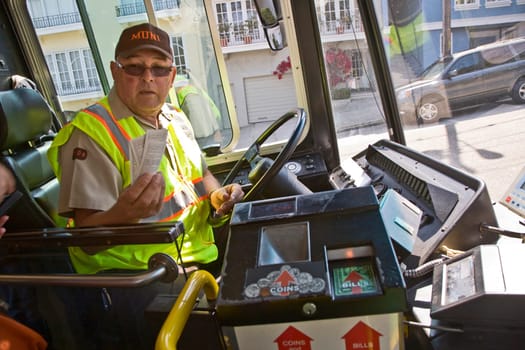 San Francisco, USA - July 24, 2008: bus driver sells bus tickets and hands over the tickets after payment.