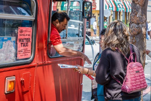 San Francisco, USA - July 25, 2008:  a friendly bus driver explains the female tourists the way by using a map.