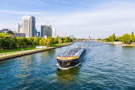 Frankfurt, Germany - August 31, 2008:  view to river main with boat and skyline in Frankfurt, Germany. The Main river with a length of 527 km is the most significant right tributary of the Rhine.