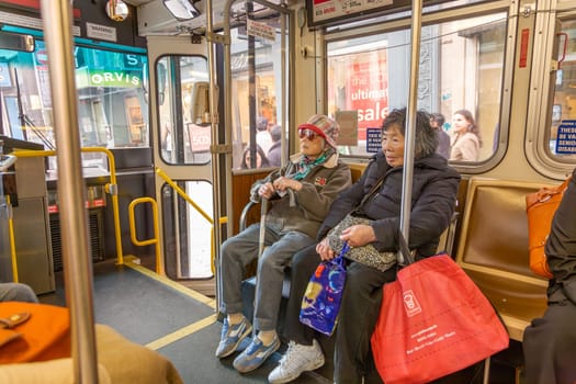 San Francisco, USA - July 24, 2008: people using the bus in downtown San Francisco. In San Francisco, bus riding is cheap, quick and often used by locals and tourists.