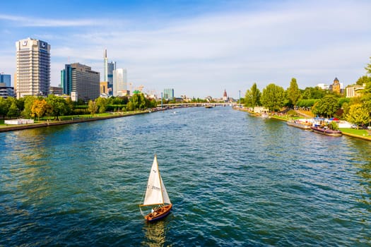 Frankfurt, Germany - August 31, 2008:  view to river main with boat and skyline in Frankfurt, Germany. The Main river with a length of 527 km is the most significant right tributary of the Rhine.