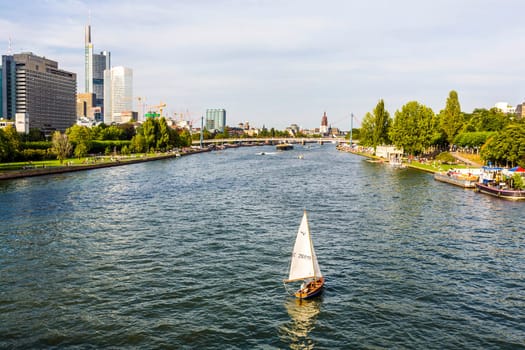 Frankfurt, Germany - August 31, 2008:  view to river main with boat and skyline in Frankfurt, Germany. The Main river with a length of 527 km is the most significant right tributary of the Rhine.