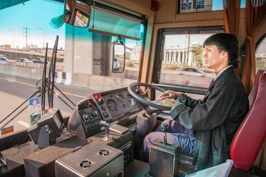 Bangkok, May 6, 2009: bus driver is goint on the motorway to downtown Bangkok with left hand drive.