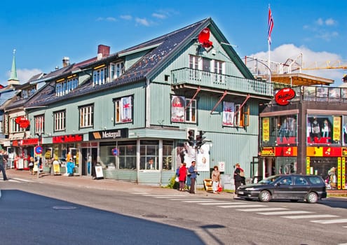 Tromso,  Norway - July 8, 2009: tromsoya island - city of tromso with old wooden houses at the main street in town.