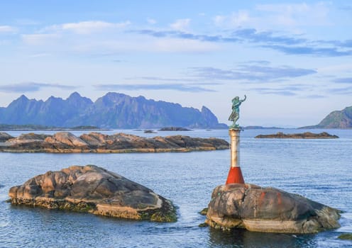 Svolvaer, Norway - July 7, 2009: View of the fiskarkona (the fishwife) sculpture at the entrance to Svolvaer harbor in Nordland County, Lofoten Islands, Norway.