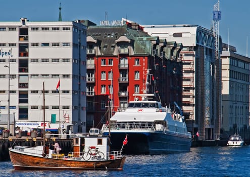 Bergen, Norway - July 4, 2009: ferry and old fishermans boat in the harbor of  Bergen, Norway, UNESCO world heritage site