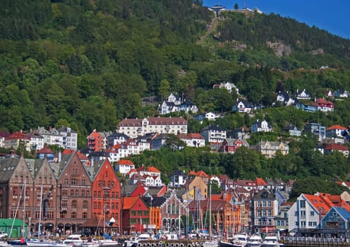 Bergen, Norway - July 3, 2009: Famous Bryggen street at harbor with wooden colored houses in Bergen, Norway, UNESCO world heritage site