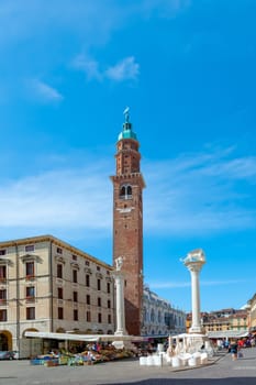 Vicenza, Italy - August 4, 2009: people walk along the Piazza del Signori  in Vicenza, Italy. The torre was build by famous architect Andrea Palladio.