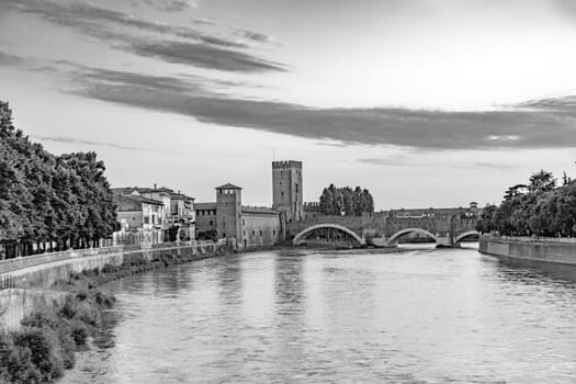 skyline of verona with river adige and old roman bridge in sunset