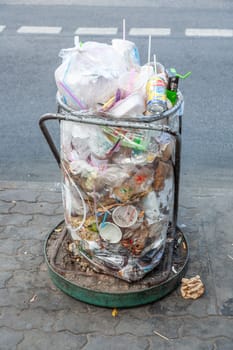 Bangkok, Thailand - December 22, 2009: trash can full of plastic litter in Bangkok, Thailand.