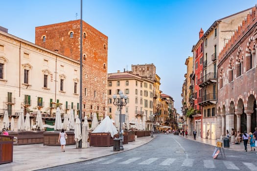 Verona, Italy - August 4, 2009:  people visit the old medieval town of Verona in late afternoon in summer time.