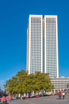 Frankfurt, Germany - October 9, 2009: view to modern skyscraper  in Frankfurt with people at town square.