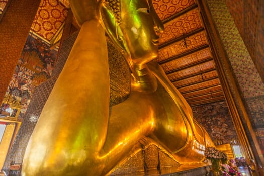 Bangkok, Thailand - January 4, 2010: Detail of the Reclining Buddha statue in temple Wat Pho in Bangkok, Thailand. Statue is 15 m high and 43 m long with his right arm supporting head.