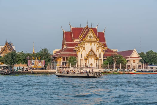 Bangkok, Thailand- January 4, 2010: people travel in the morning with longboats at the river Chao Phraya in Bangkok. The boats belong to Bangkok public transportation system..
