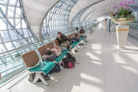 Bangkok, Thailand - January 5, 2010: passengers wait at the departure gate for the boarding call of their flight in the new Bangkok airport Suvarnabhumi.