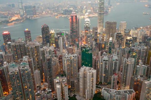 Victoria, Hong Kong - January 8, 2010: view by night from Victoria peak to the skyline and harbor of Hong Kong with spectacular skyscraper scene.