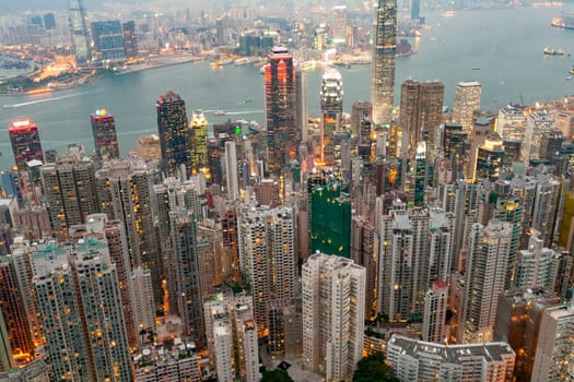 Victoria, Hong Kong - January 8, 2010: view by night from Victoria peak to the skyline and harbor of Hong Kong with spectacular skyscraper scene.