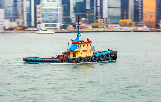 Victoria, Hongkong - January 8, 2010: tug boat cruising Victoria harbor