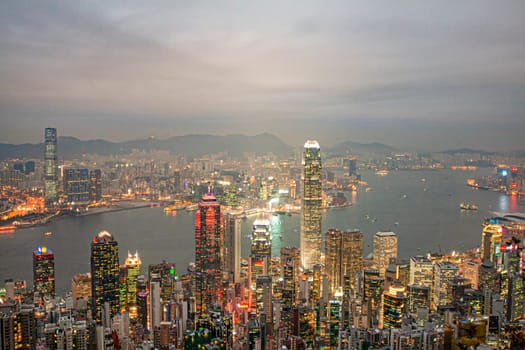 Victoria, Hong Kong - January 8, 2010: view by night from Victoria peak to the skyline and harbor of Hong Kong with spectacular skyscraper scene.